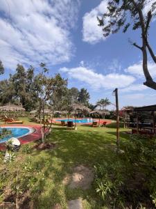 a view of a park with a swimming pool at Bungalows de Casa Verde in Mala