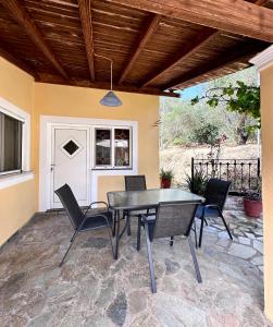 a dining table and chairs on a patio at Katerinas House 2 in Skriperón