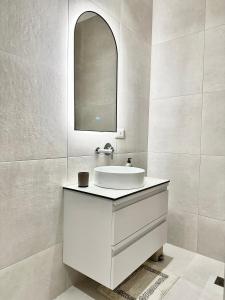 a white bathroom with a sink and a mirror at O'Det Luxury Rooms & Apartments in Sarandë +62 photos