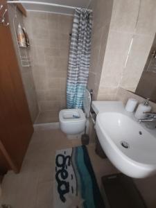 a bathroom with a toilet and a sink at 89 Steps Symi in Symi
