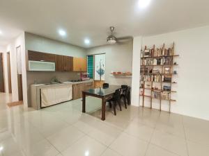 a kitchen and dining room with a table and chairs at Homelite Resort in Miri