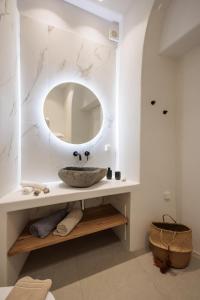 a bathroom with a sink and a mirror at Casa di Grazia in Naxos Chora