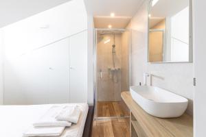 a white bathroom with a tub and a shower at Novalja Centar Retreat in Novalja +19 photos