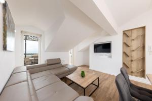 a living room with a couch and a tv at Novalja Centar Retreat in Novalja