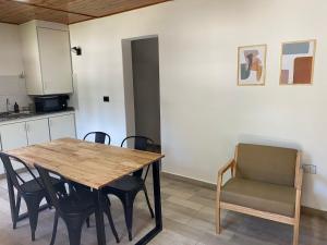 a kitchen with a wooden table and chairs at El Amanecer in Esquel