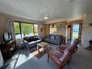 a living room with a couch and a table at Home Away From Home in Cromwell