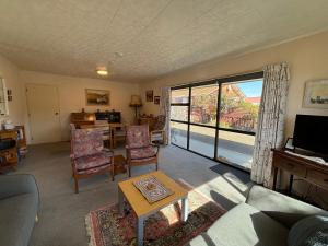 a living room with a couch and chairs and a television at Home Away From Home in Cromwell +6 photos