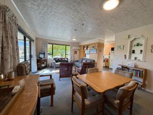 a living room with a wooden table and chairs at Home Away From Home in Cromwell