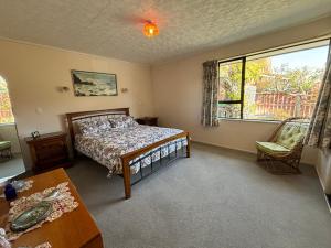 a bedroom with a bed and a large window at Home Away From Home in Cromwell