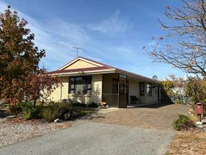a house with a dog sitting outside of it at Home Away From Home in Cromwell