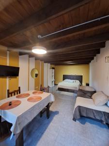 a room with two beds and a flat screen tv at Tierra De Mestizos in Villa La Angostura