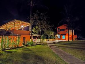 a house at night with the lights on at Lagamar Eco Hotel in Cananéia +72 photos
