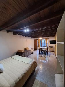 a bedroom with a bed and a dining room at Tierra De Mestizos in Villa La Angostura