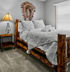 a bedroom with a bed and a table with a lamp at Let's Go ! Highly Rated, Location Perfect, Pools One Minute, Amenity-Rich with Wonderful Comfort, and Pup Friendly, Discover An Exceptional Wyoming Stay, Thermopolis River Walk Home at Hot Springs State Park, 'Where Families and Fisherman Stay' in Thermopolis +45 photos