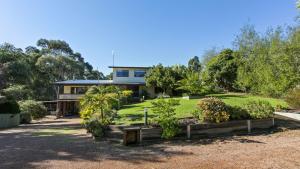 a house with a garden in front of it at Treetop Retreat in Metung