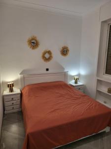 a bedroom with a bed and two mirrors on the wall at Appartement front de mer Tanger in Tangier