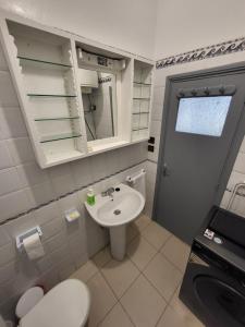 a small bathroom with a sink and a toilet at Appartement front de mer Tanger in Tangier +11 photos