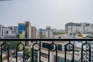 a balcony with a view of a city at Nohyung Hotel in Jeju