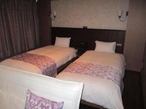 Postel nebo postele na pokoji v ubytování Town Hotel 41