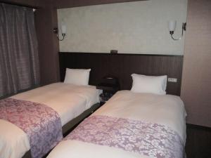 Postel nebo postele na pokoji v ubytování Town Hotel 41