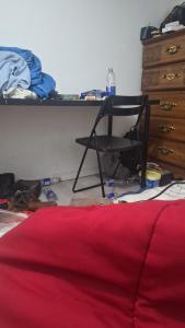 a room with a chair and a desk and a bed at guest house panorama GJirokaster in Gjirokastër