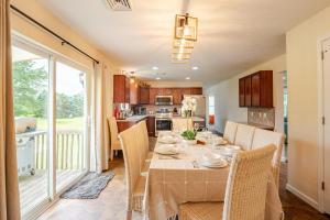 a kitchen and dining room with a table and chairs at Huge villa in the hearth of Poconos near all. in Long Pond
