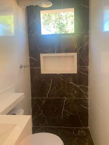 un bagno con wc e finestra di RANCHO NATURE piscina e hidromassagem no LAGO CORUMBÁ 4 ALEXANIA a Alexânia Altre 26 foto
