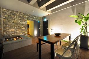 a living room with a table and a fireplace at Gout Stay in Daegu