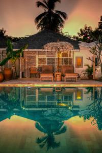 a house with a swimming pool in front of it at Les Villas Ottalia Gili Meno in Gili Meno