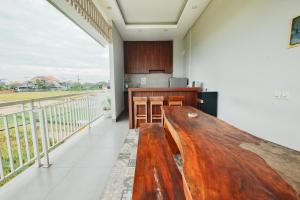 a kitchen with a wooden bench on a balcony at Puspa Canggu in Canggu +19 photos