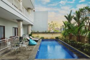 a swimming pool on the balcony of a house at Puspa Canggu in Canggu