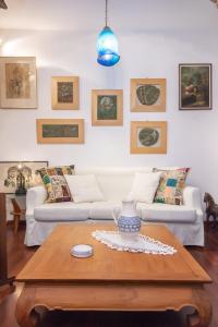 a living room with two couches and a table at Gladiolus House - Tinos in Tzádhos