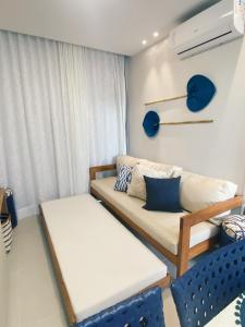 a living room with a couch and a window at Sunny Hall - Porto de Galinhas in Porto De Galinhas