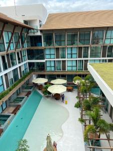 an aerial view of a hotel with a pool and umbrellas at Sunny Hall - Porto de Galinhas in Porto De Galinhas