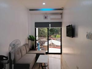 a living room with a couch and a table at 80Square Guest House in Gingoog