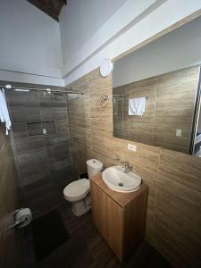 a bathroom with a toilet and a sink and a shower at El EmAnJe 1 in Jardin