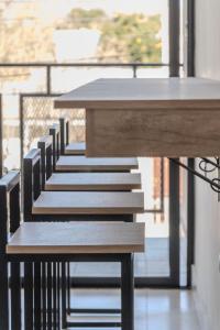 a row of tables and chairs on a balcony at Cajón de Agua in Cafayate +24 photos