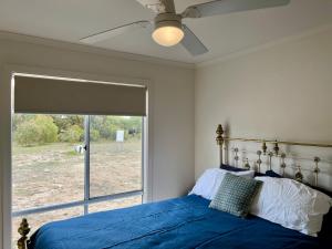 罗布Ramblers Croft - WiFi Pet Friendly inside的卧室里有一张床，床铺是蓝色的，还有一扇窗户
