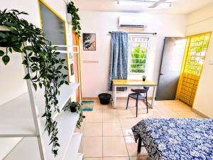 a room with a bed and a table and a desk at Private Room with Bathroom in Kuala Lumpur