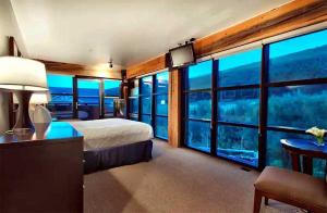 a hotel room with a bed and large windows at Main & SKY by EXMAR in Park City +28 photos