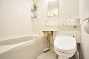 a bathroom with a toilet and a sink and a bath tub at Rikyuan Kyoto Nishikyogoku in Kyoto