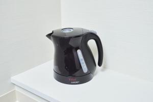 a black tea kettle sitting on a white counter at Rikyuan Kyoto Nishikyogoku in Kyoto