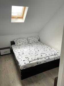 a bedroom with a bed with a black frame at Casa din dâmb in Cluj-Napoca