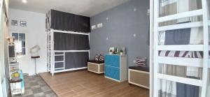a room with two bunk beds and a desk at ELTARI Pine House in Kidal