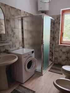 a bathroom with a shower and a washing machine at Villa Panorama in Lipari