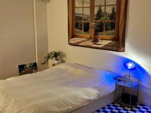 a bedroom with a white bed with a window at Momo House2 in Gimhae +7 photos