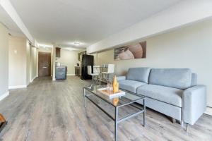 a living room with a couch and a table at A Spacious Downtown 1-bed Suite in Calgary