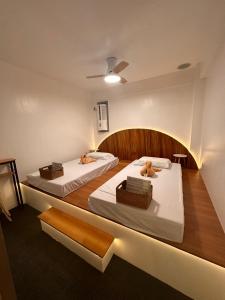 two beds in a room with two dogs on them at Treeshade Resort & Spa Moalboal in Moalboal +176 photos