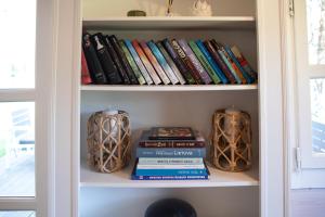 a book shelf filled with books and vases at Mystica Forest in Braziūkai
