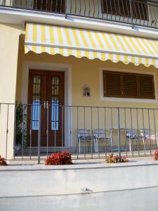 a balcony of a house with chairs and a fence at B&B Locanda La Rotonda in Montale